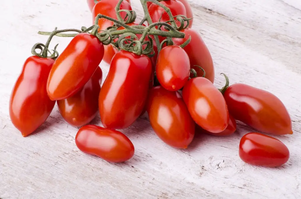 San Marzano tomatoes laid down on a light wooden table