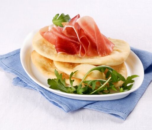 Gnocco fritto fried Italian flatbreads with cured ham and rocket