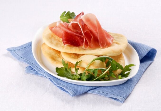 Gnocco fritto fried Italian flatbreads with cured ham and rocket
